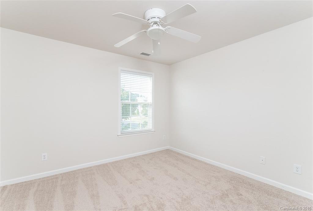 2413 Coltsgate Road Waxhaw, NC 28173 - Photo 21 of 24 an empty room with a window and a fan