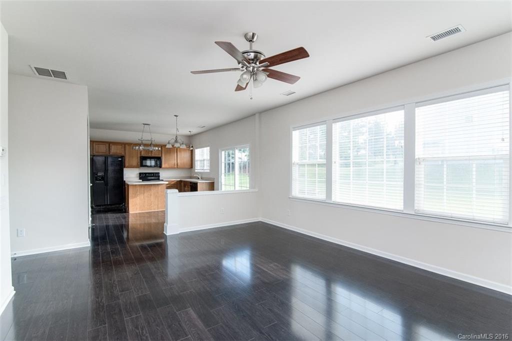 2413 Coltsgate Road Waxhaw, NC 28173 - Photo 9 of 24 a living room with stainless steel appliances kitchen island furniture and a window