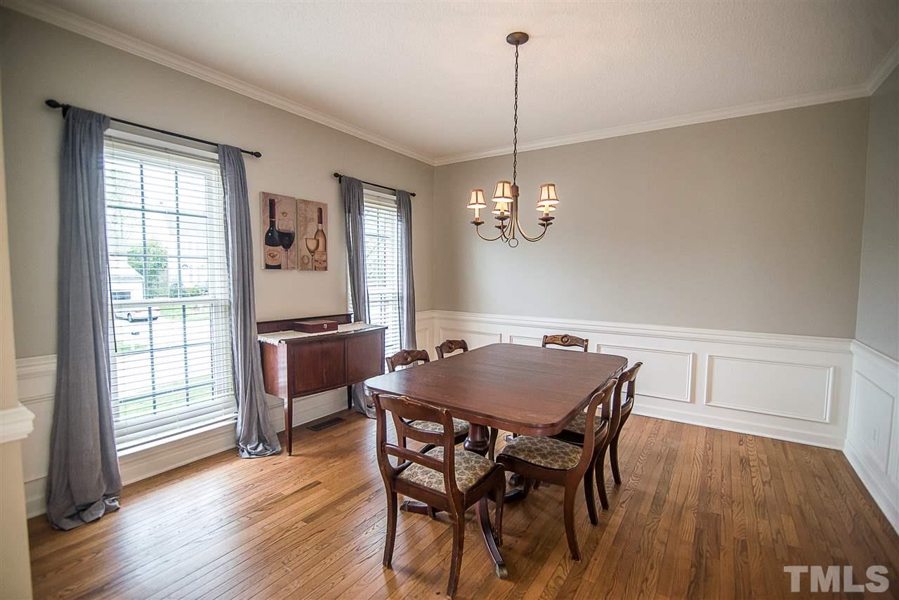 5204 Camfirth Way Raleigh, NC 27613 - Photo 3 of 21 a view of a dining room with furniture window and wooden floor