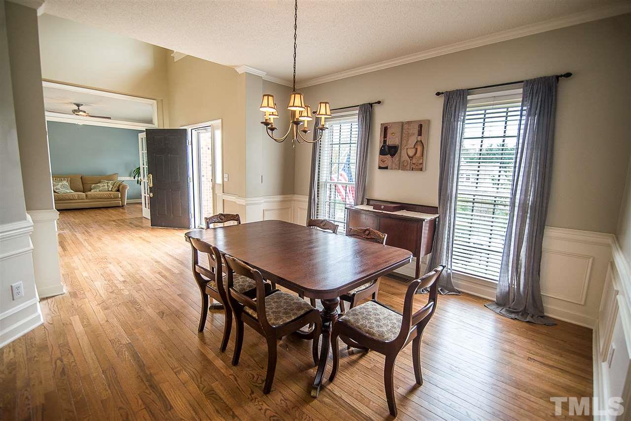 5204 Camfirth Way Raleigh, NC 27613 - Photo 4 of 21 a view of a dining room with furniture window and wooden floor