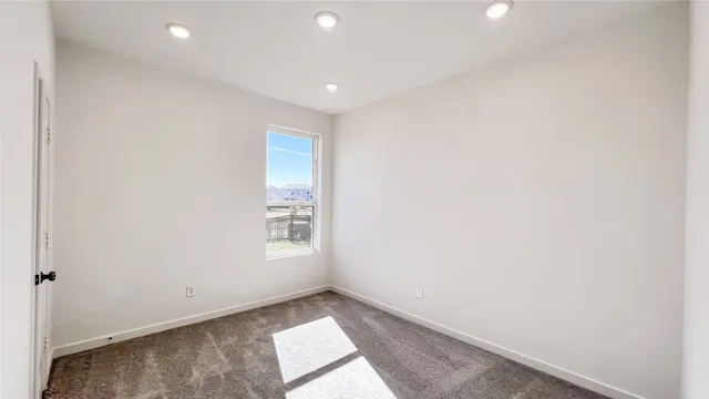 a view of an empty room and a window