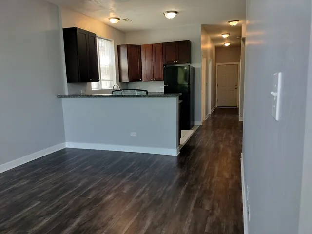 a kitchen with stainless steel appliances granite countertop a refrigerator and a sink