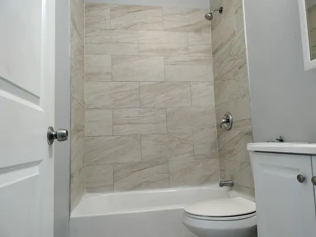 a bathroom with a bathtub and a toilet