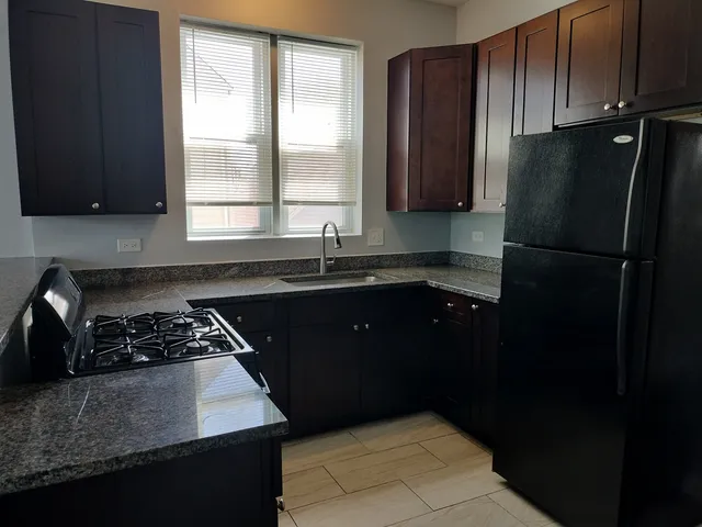 a kitchen with a sink a refrigerator and a stove