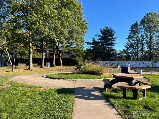 a view of a table and chairs under an umbrella