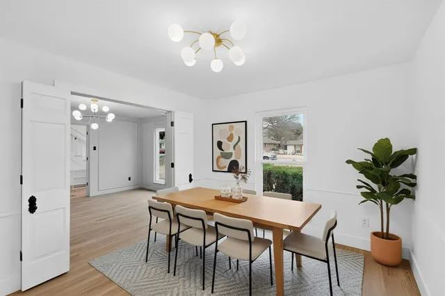 a view of a dining room with furniture and chandelier