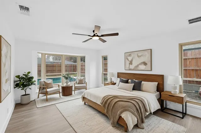 a bedroom with a large bed potted plant and a large window