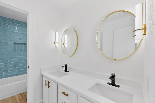 a bathroom with a sink a mirror and a shower