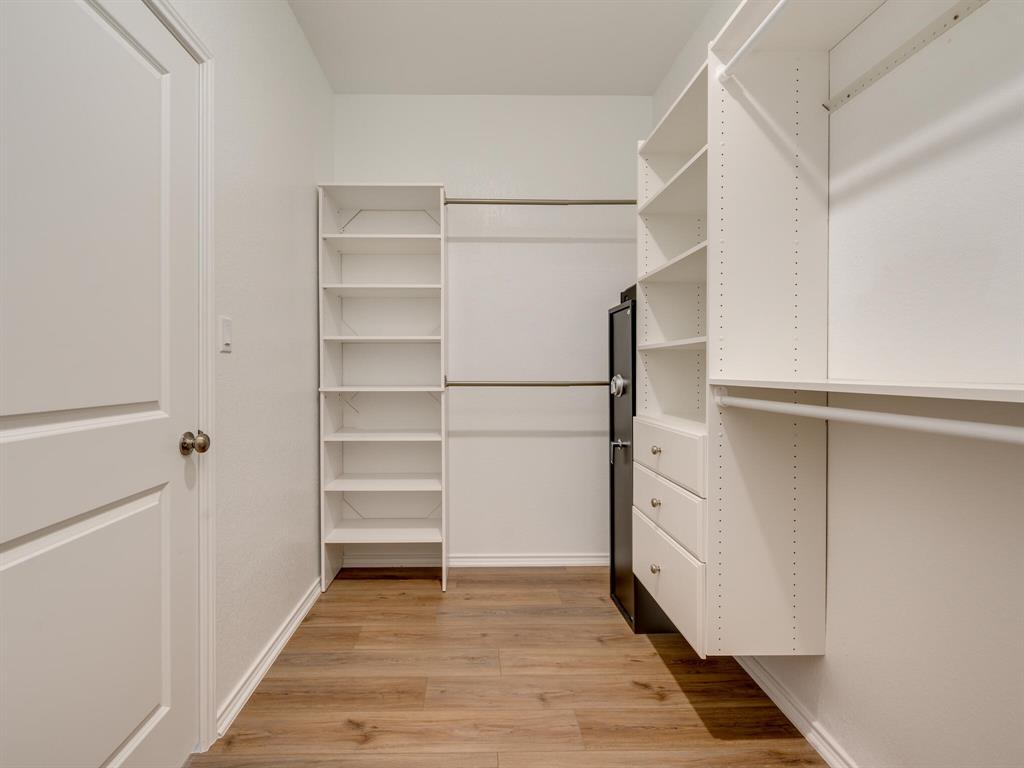 1208 Sweetspire Street Leander, TX 78641 - Photo 19 of 36 Customizable closet system featuring built-in shelving, hanging rods, and integrated drawers