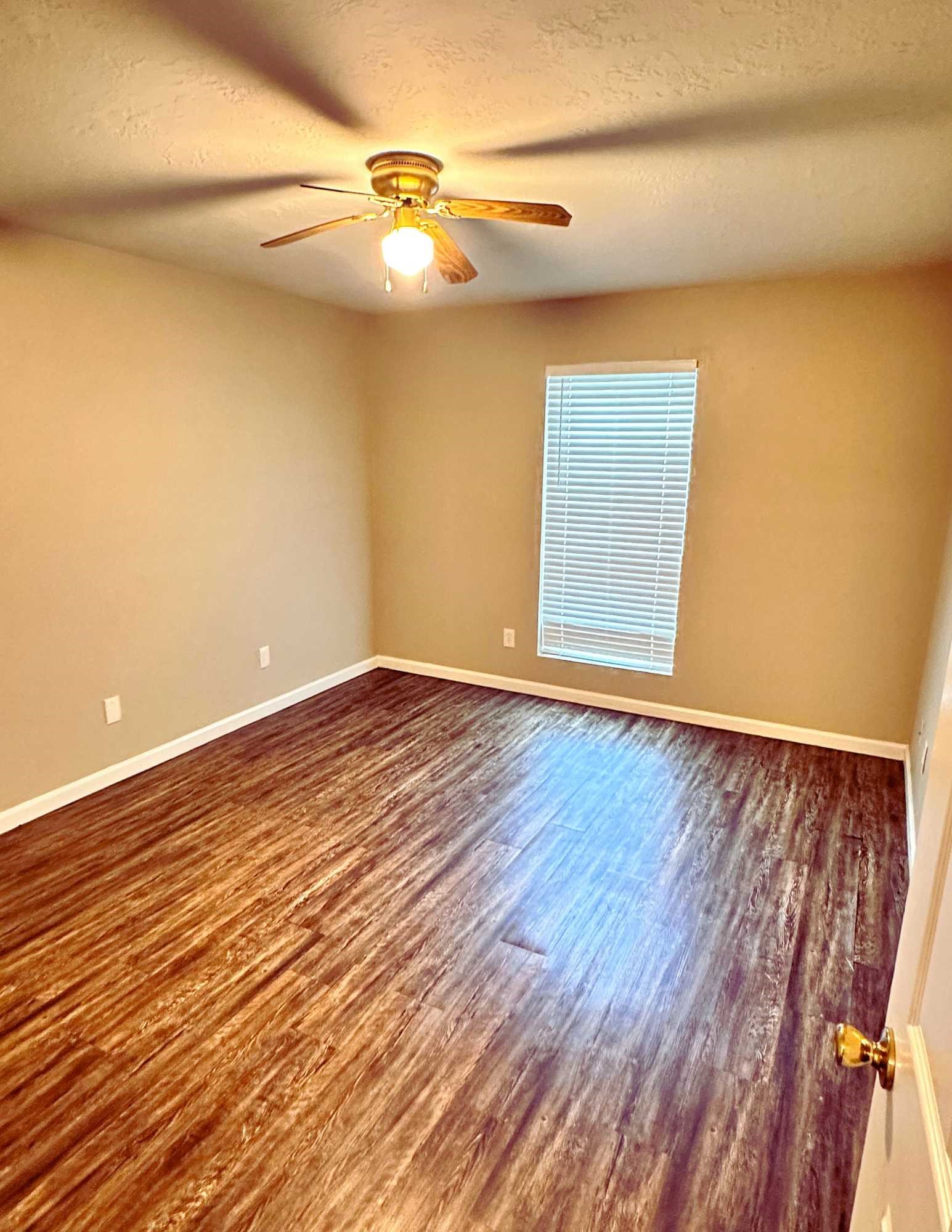 22707 Bridgewater Drive Spring, TX 77373 - Photo 8 of 11 a view of an empty room with wooden floor and a window
