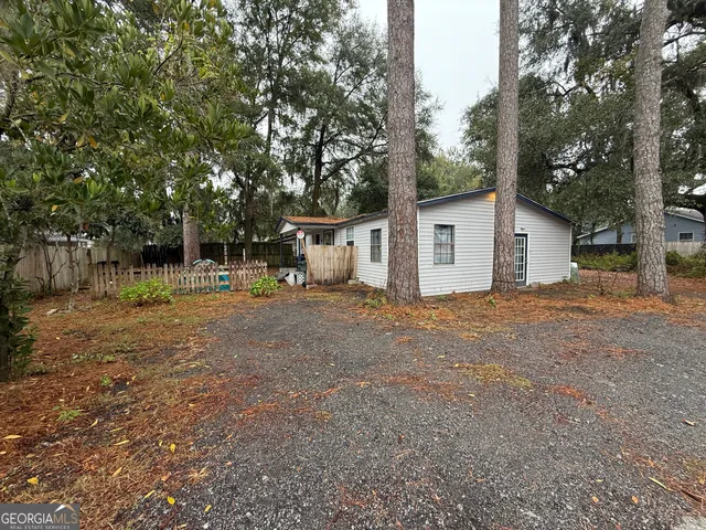 a view of a house with a yard and tree
