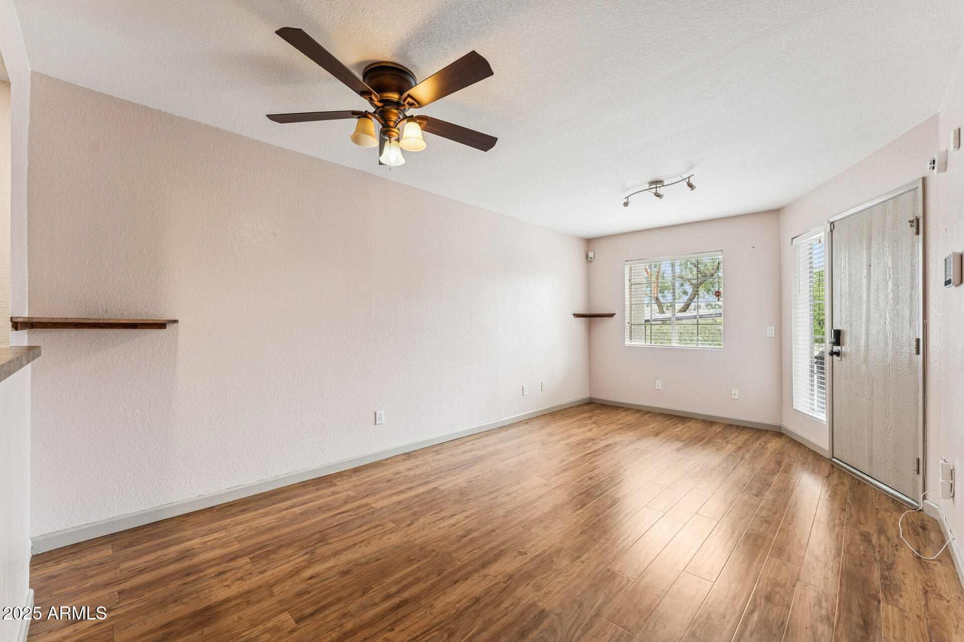 1720 East Thunderbird Road, Unit 1070 Phoenix, AZ 85022 - Photo 3 of 19 wooden floor in an empty room with a window