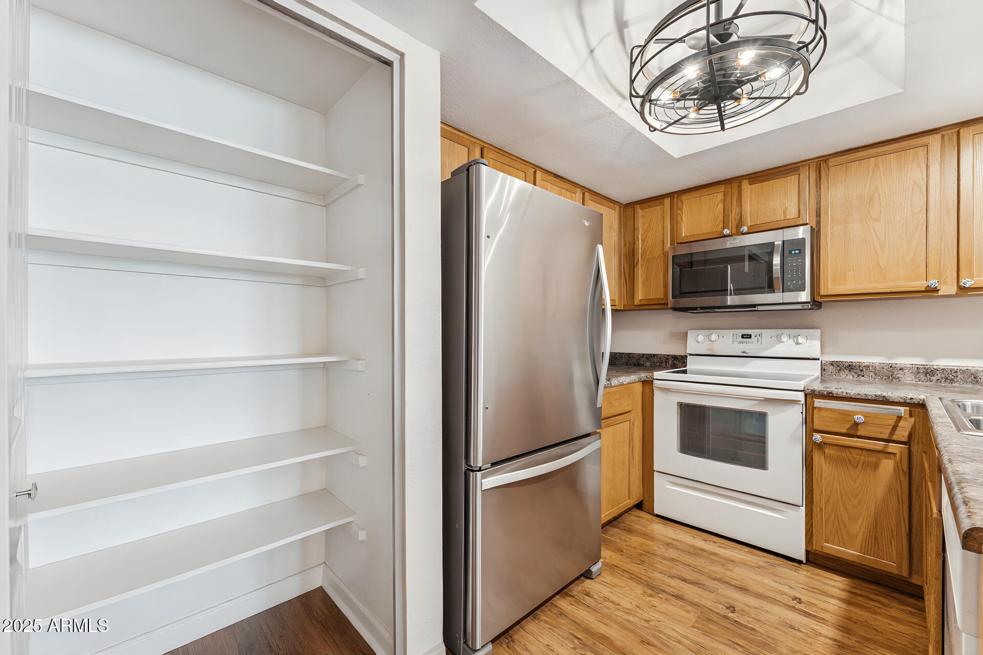 1720 East Thunderbird Road, Unit 1070 Phoenix, AZ 85022 - Photo 7 of 19 a kitchen with a stove microwave and a refrigerator