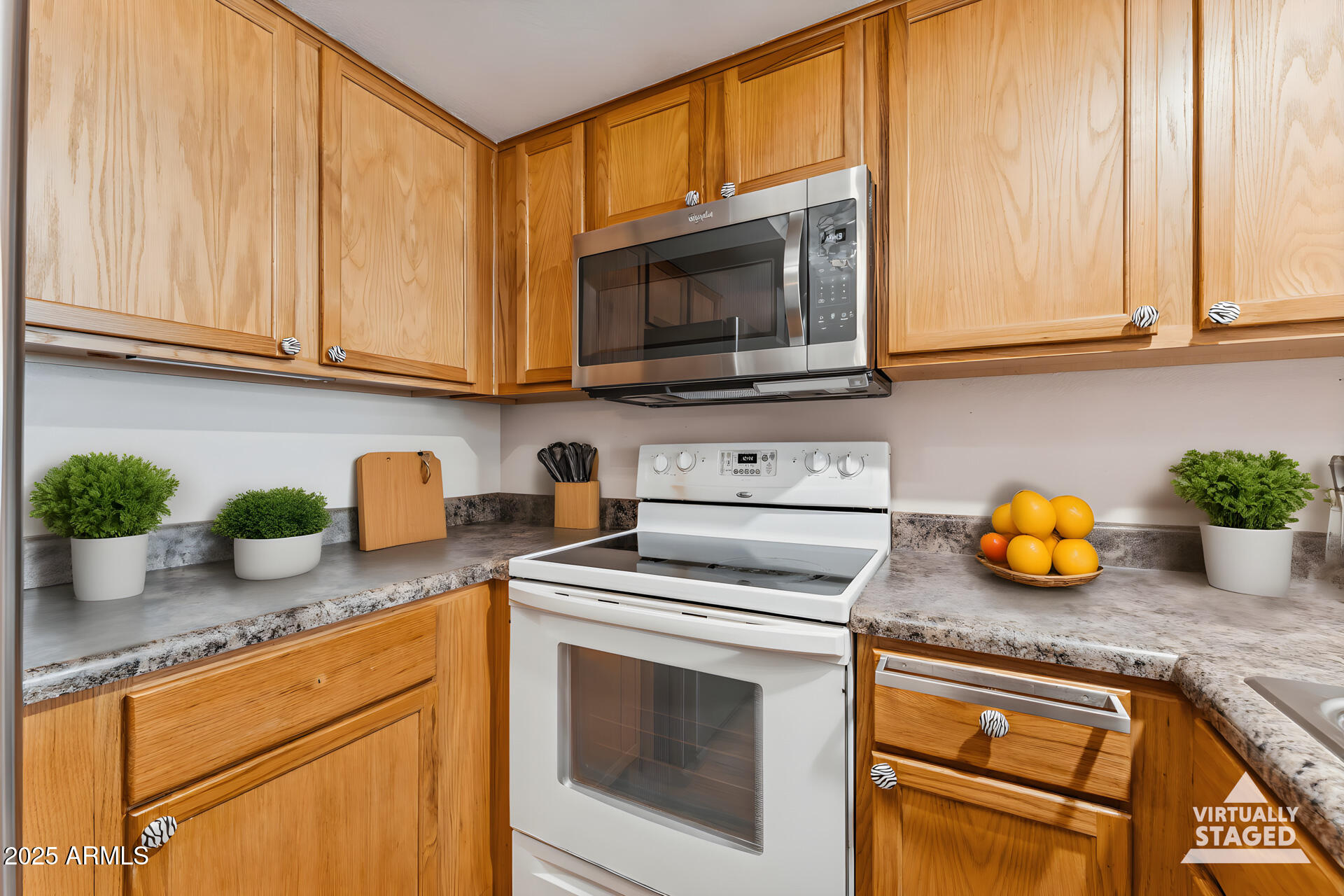 1720 East Thunderbird Road, Unit 1070 Phoenix, AZ 85022 - Photo 8 of 19 a kitchen with stainless steel appliances granite countertop a sink a stove and a wooden floor