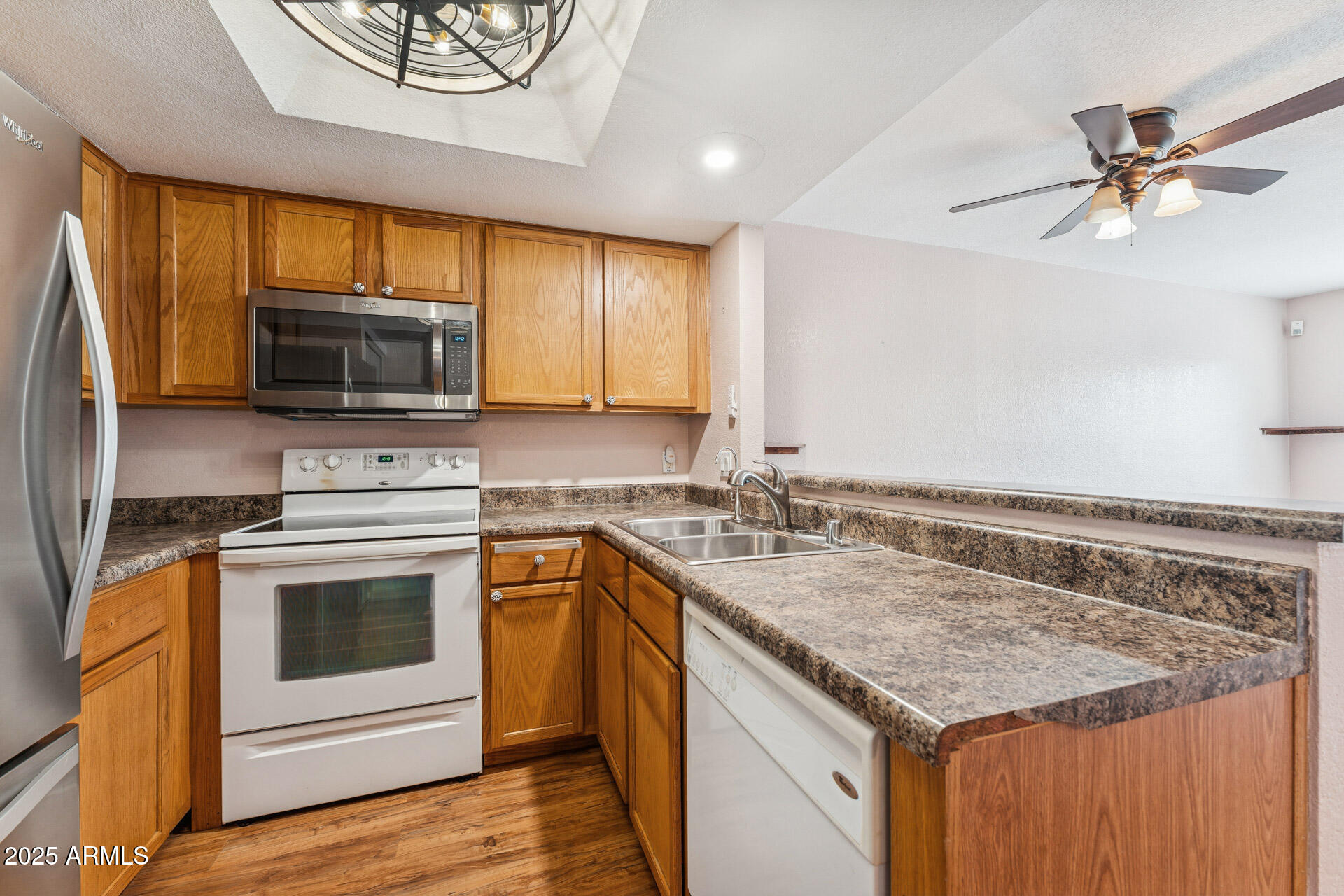 1720 East Thunderbird Road, Unit 1070 Phoenix, AZ 85022 - Photo 9 of 19 a kitchen with a stove a sink and a microwave