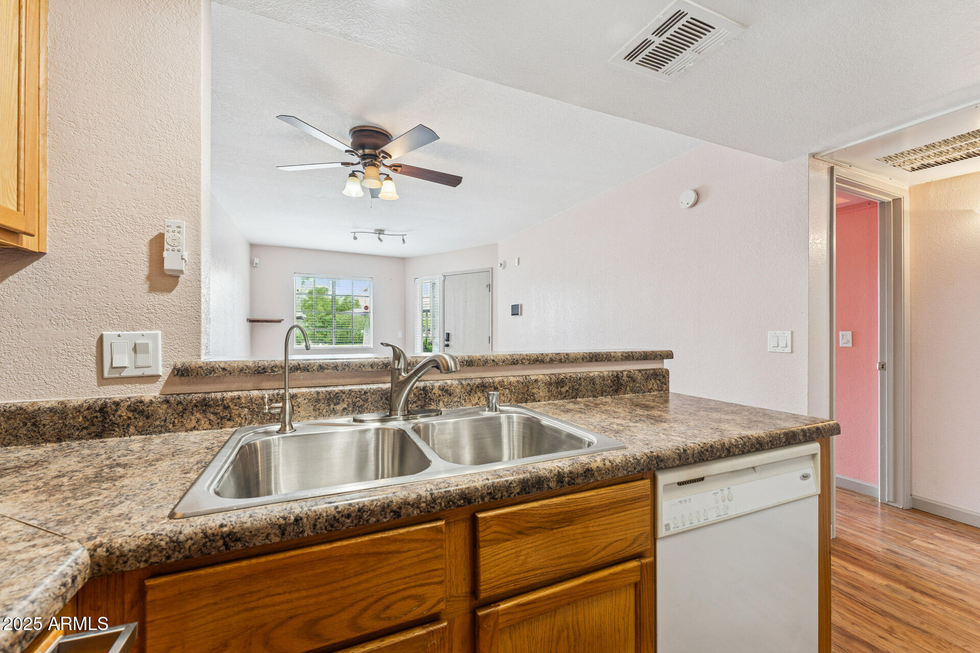 1720 East Thunderbird Road, Unit 1070 Phoenix, AZ 85022 - Photo 10 of 19 a kitchen with a sink granite counter tops and a view of living room
