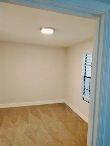 a bathroom with a granite countertop toilet a sink and a large mirror