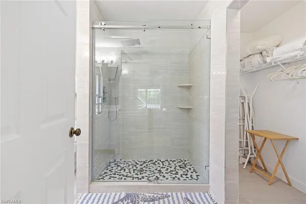 a bathroom with a shower and a sink