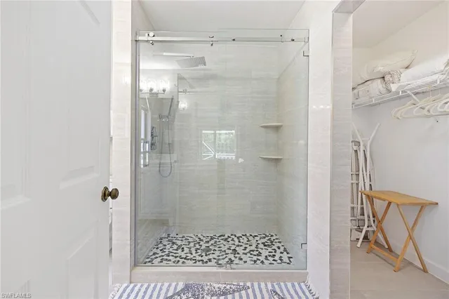 a bathroom with a shower and a sink