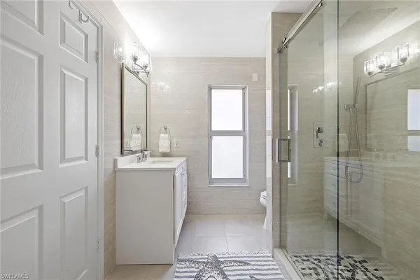 a bathroom with a shower sink and mirror