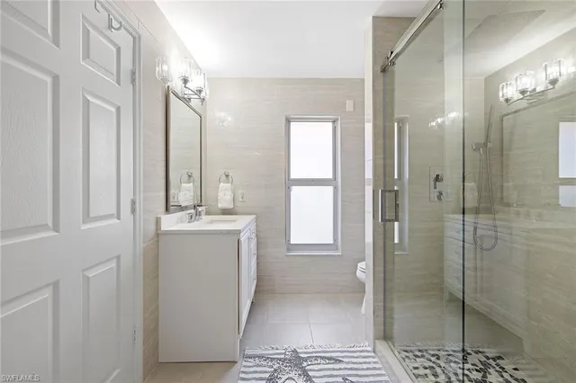 a bathroom with a shower sink and mirror