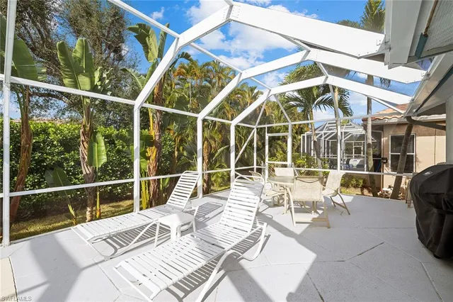 a view of a patio with couches chairs and wooden floor