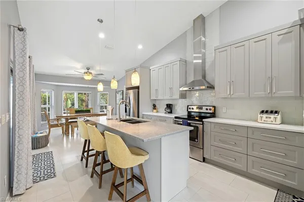 a kitchen with stainless steel appliances granite countertop a stove refrigerator and cabinets