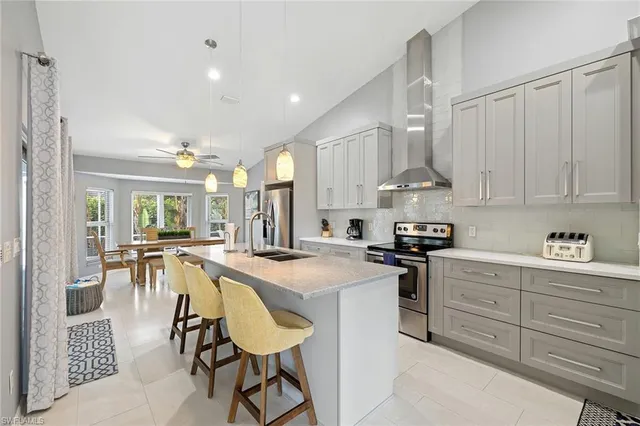 a kitchen with stainless steel appliances granite countertop a stove refrigerator and cabinets