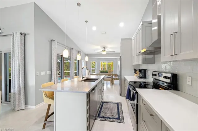 a kitchen with counter top space a sink stainless steel appliances and cabinets