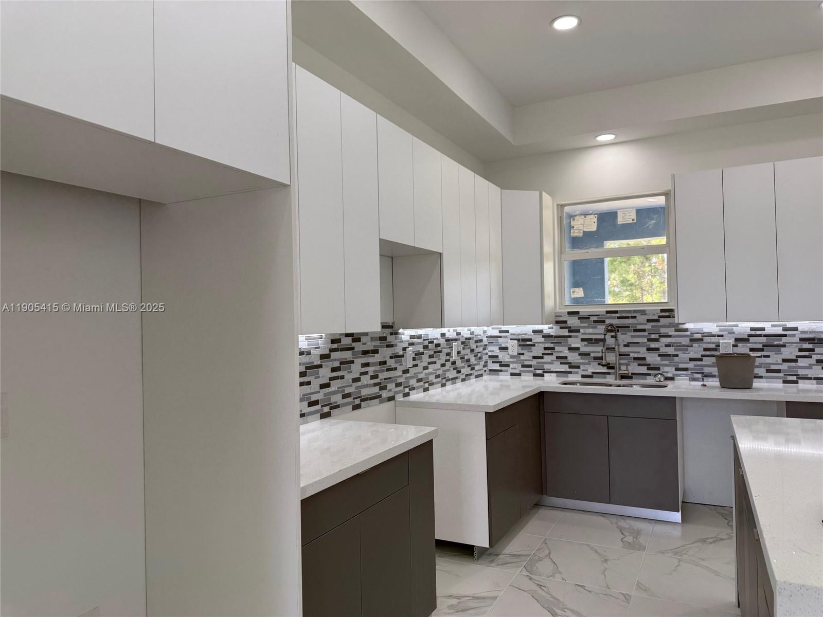 617 Valley Avenue Lehigh Acres, FL 33974 - Photo 16 of 46 a kitchen with granite countertop a sink and a stove