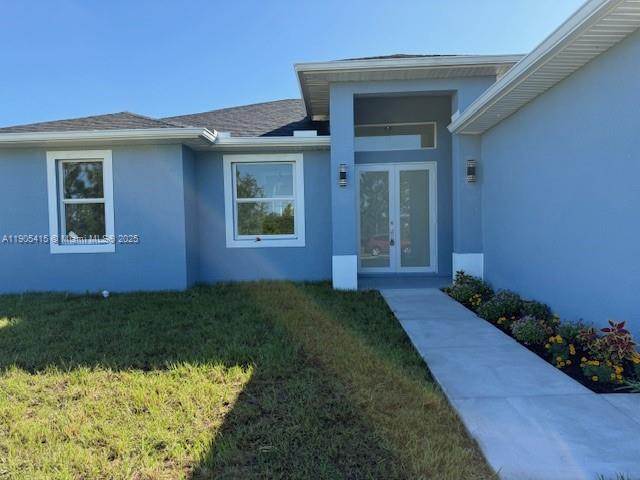 617 Valley Avenue Lehigh Acres, FL 33974 - Photo 2 of 46 a view of a house with a yard