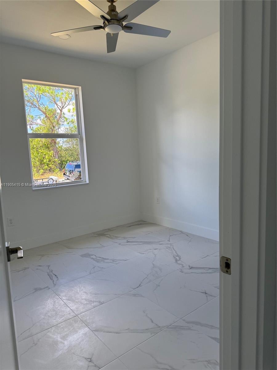 617 Valley Avenue Lehigh Acres, FL 33974 - Photo 29 of 46 an empty room with windows