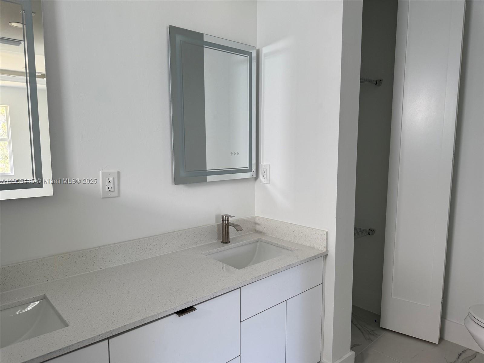 617 Valley Avenue Lehigh Acres, FL 33974 - Photo 32 of 46 a bathroom with a sink and a mirror