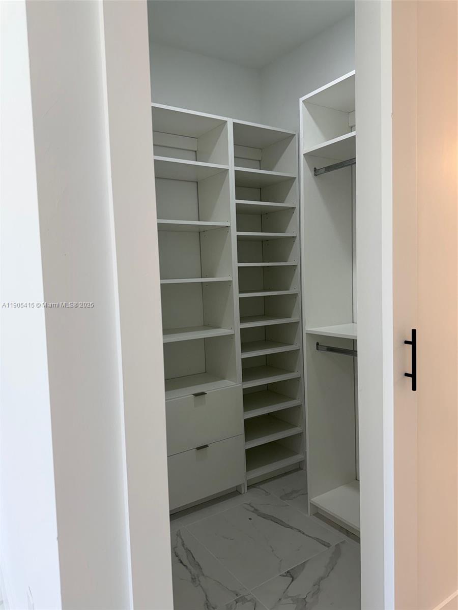 617 Valley Avenue Lehigh Acres, FL 33974 - Photo 36 of 46 a view of walk in closet with empty racks