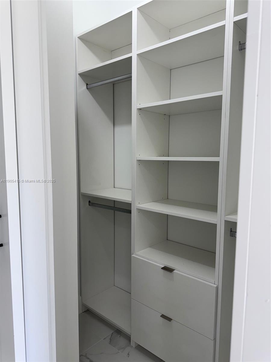 617 Valley Avenue Lehigh Acres, FL 33974 - Photo 37 of 46 a view of walk in closet with empty racks