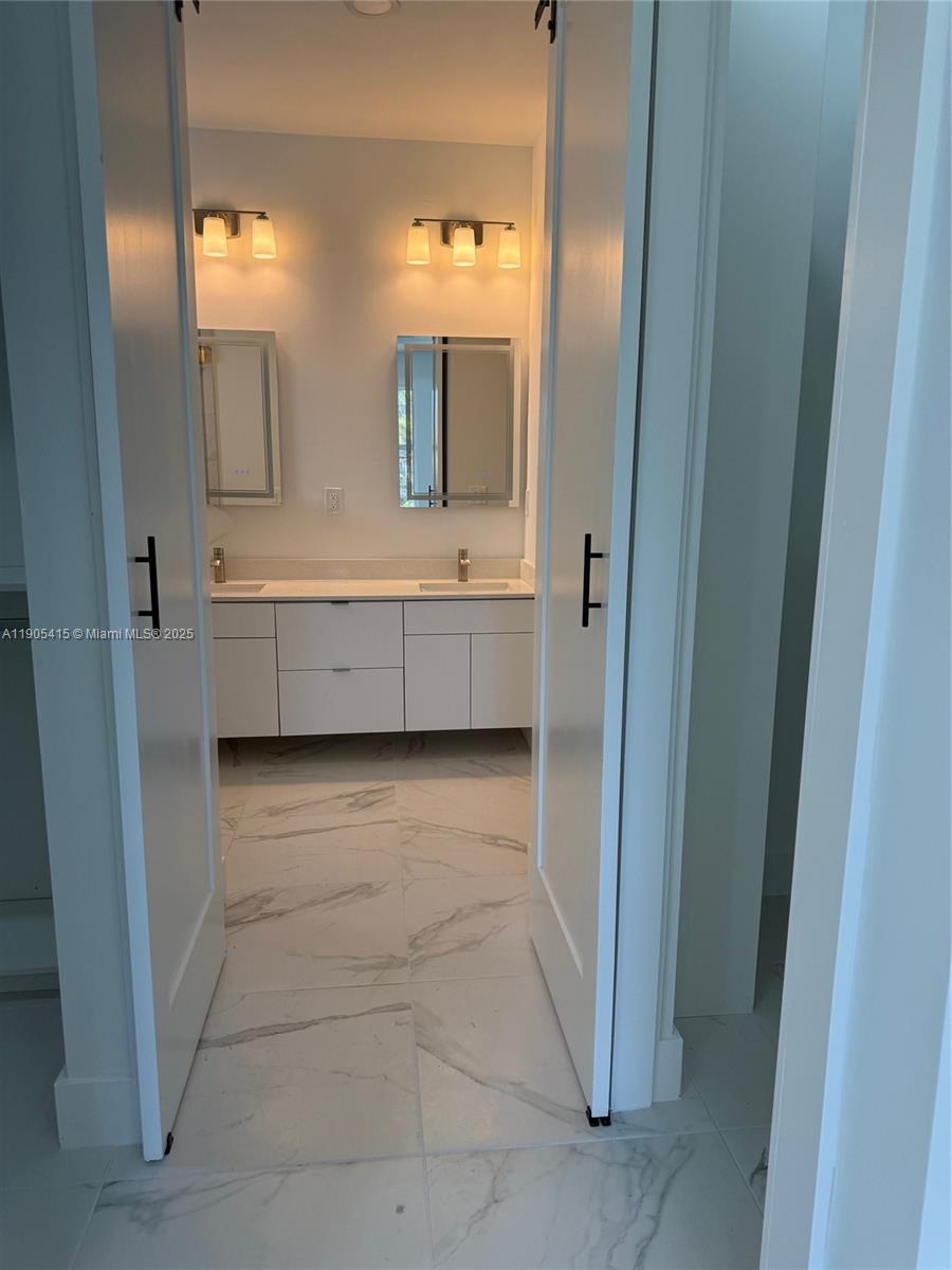 617 Valley Avenue Lehigh Acres, FL 33974 - Photo 38 of 46 a bathroom with a double vanity sink mirror and bathtub