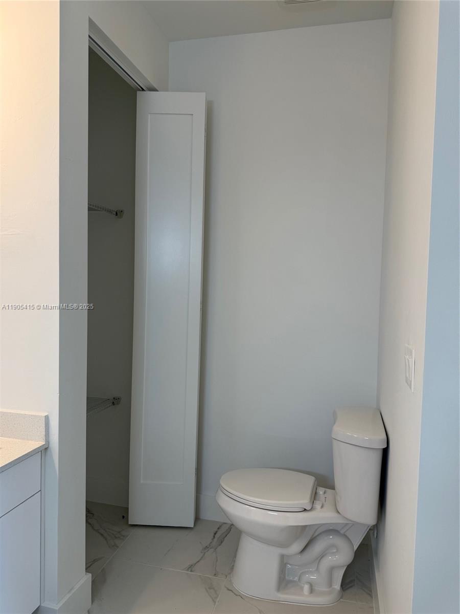 617 Valley Avenue Lehigh Acres, FL 33974 - Photo 39 of 46 a white toilet sitting next to a white cabinet