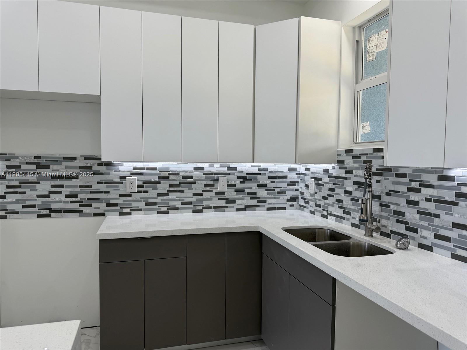 617 Valley Avenue Lehigh Acres, FL 33974 - Photo 9 of 46 a kitchen with a sink and a refrigerator