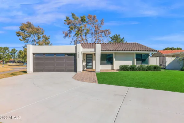 a front view of a house with a yard and garage