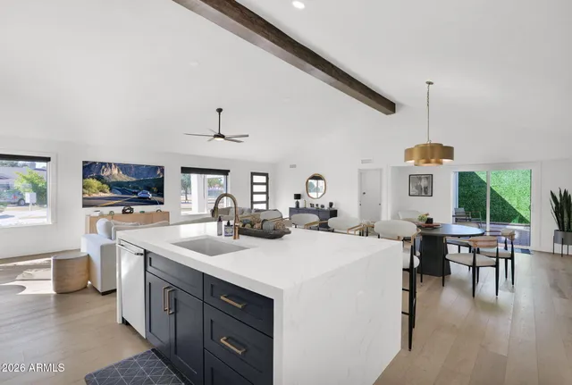 a kitchen with a sink and wooden floor
