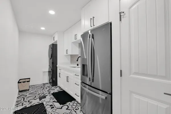 a kitchen with stainless steel appliances a refrigerator and cabinets