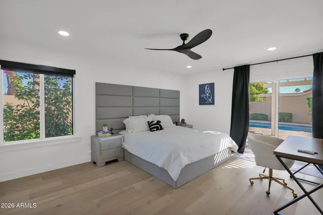 a bedroom with a bed and a large window