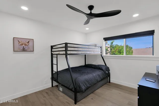 a bedroom with a bed and a ceiling fan