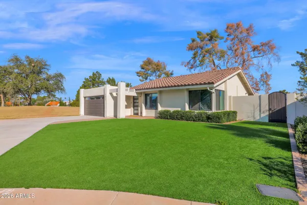 a view of a house with a backyard