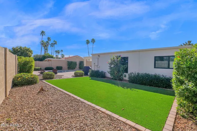 a view of a house with swimming pool and sitting area