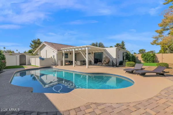 a view of a swimming pool with an outdoor seating