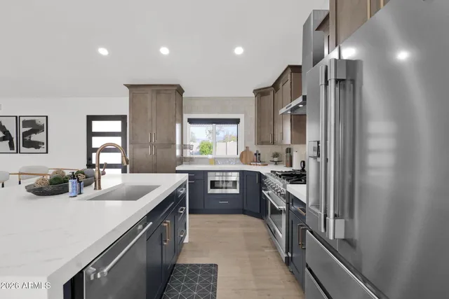 a kitchen with counter top space stainless steel appliances and cabinets