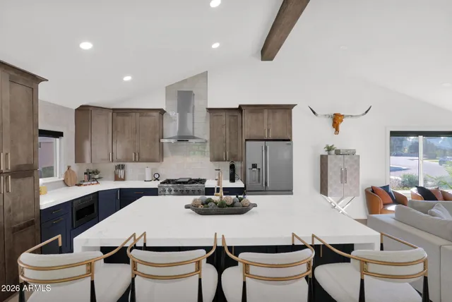 a kitchen with a dining table chairs sink and white appliances