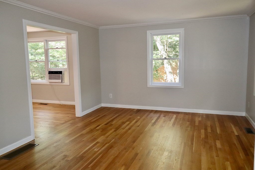 275 Burroughs Road Boxborough, MA 01719 - Photo 12 of 23 a view of an empty room with wooden floor and a window