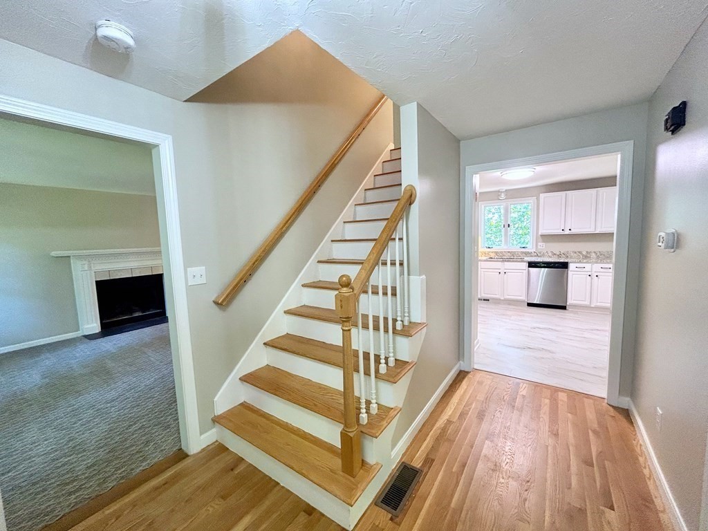 275 Burroughs Road Boxborough, MA 01719 - Photo 15 of 23 a view of a livingroom with wooden floor and staircase
